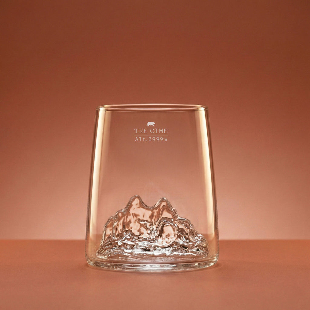 Tre Cime di Lavaredo shooter glass on a warm backdrop