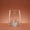Tre Cime di Lavaredo shooter glass on a warm backdrop