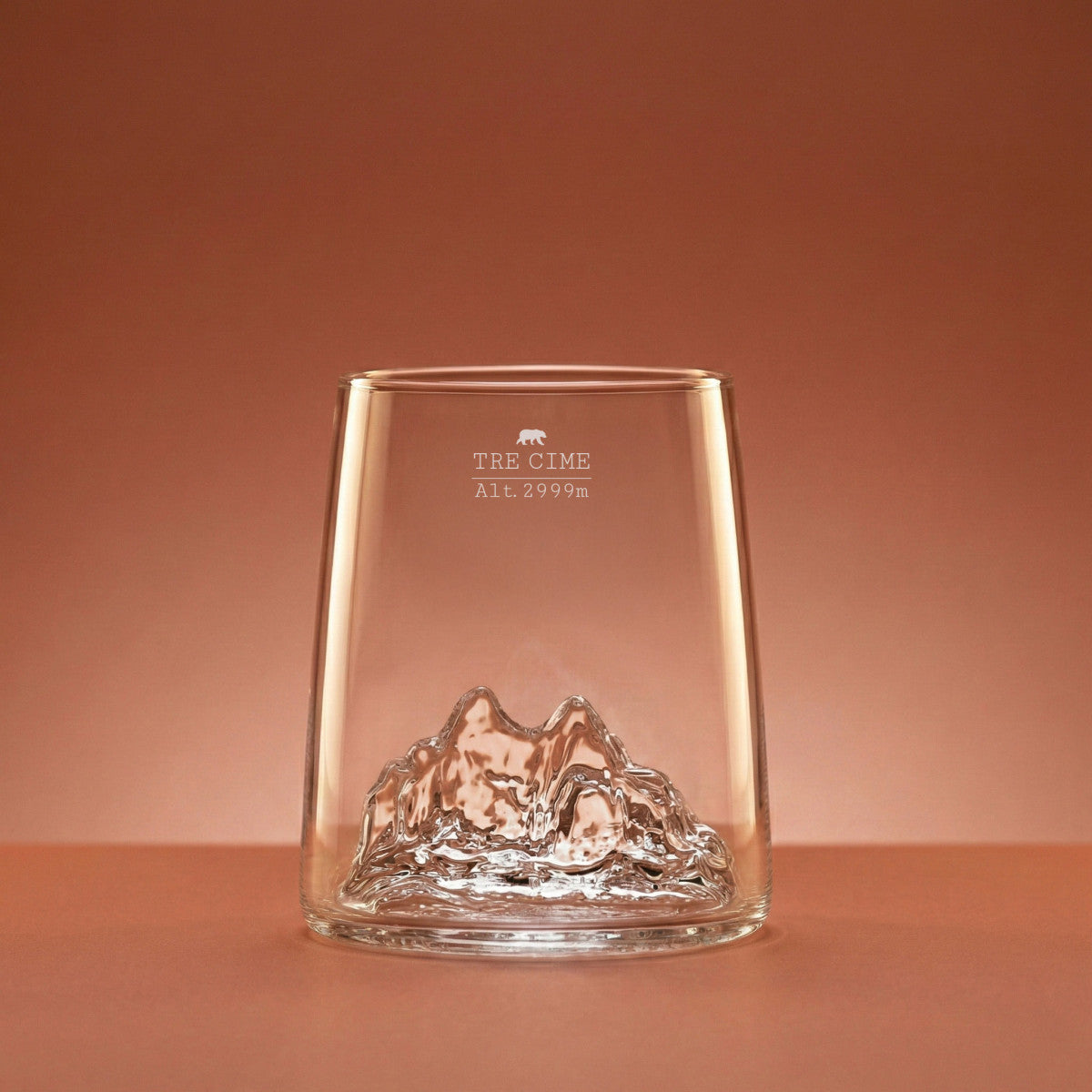 Tre Cime di Lavaredo shooter glass on a warm backdrop