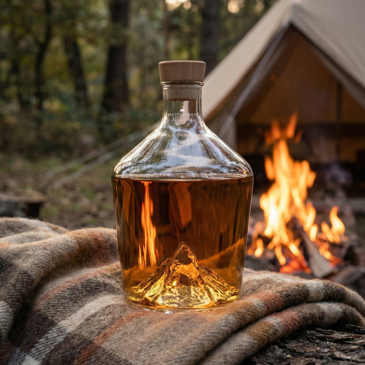 Matterhorn spirit decanter on a blanket beside a fire